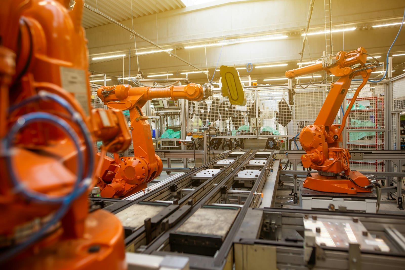 Industrial robotic arms on an automated manufacturing assembly line